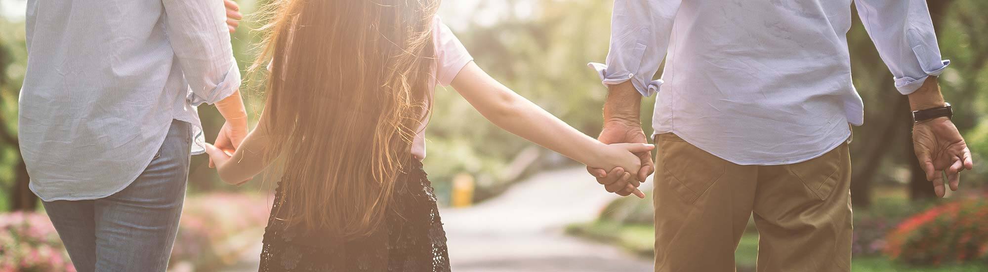 Happy family holding hands after resolving their disputes.